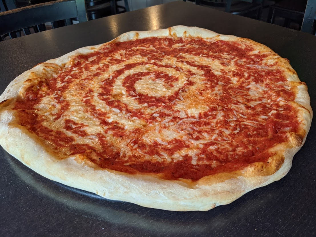 A pizza sitting on top of a table.