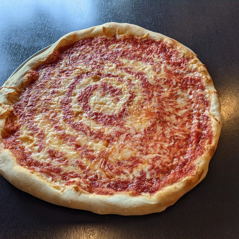 A pizza is sitting on a table.